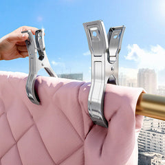 Large stainless steel household clip securing a towel outdoors