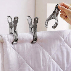 Two household clips securing a folded blanket