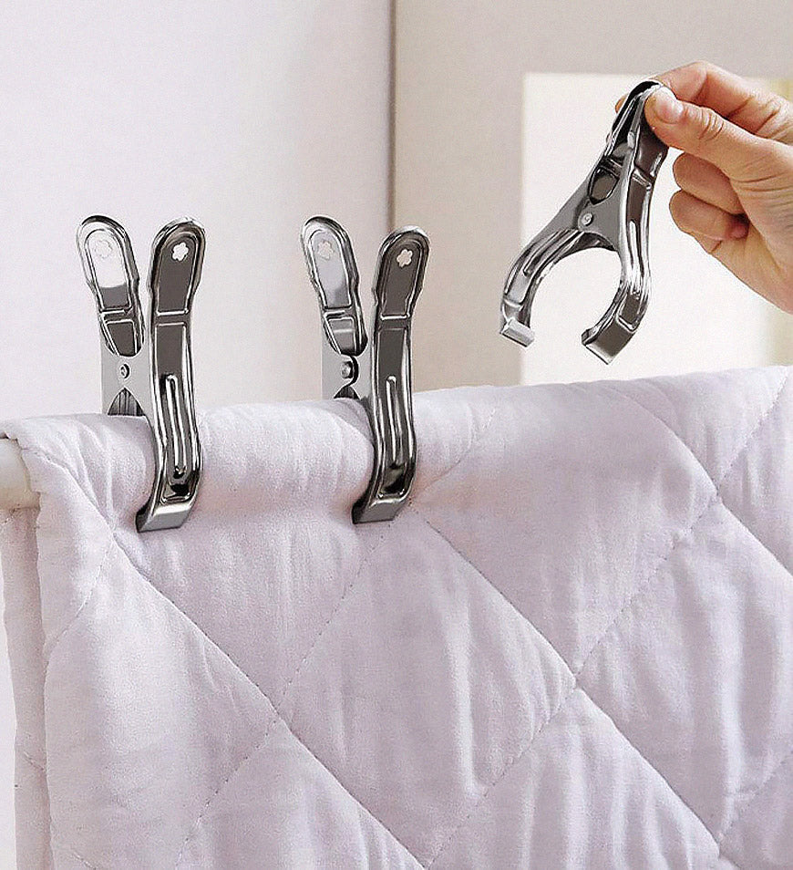 Two household clips securing a folded blanket