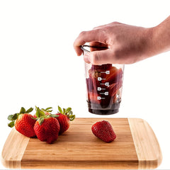 Manual food cutter used with strawberries