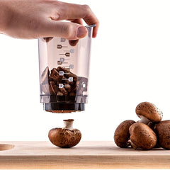 Manual food cutter chopping mushrooms over a counter