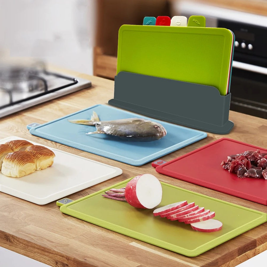 Four cutting boards used for different food-prep tasks