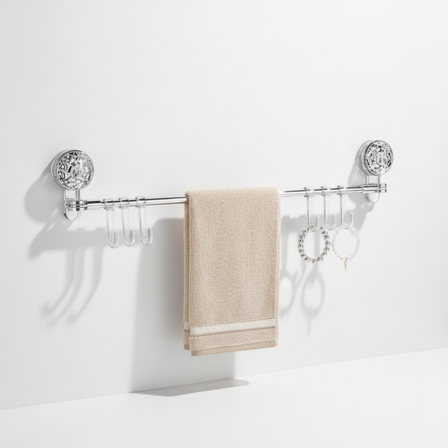 Clear retractable wall hook rack holding a towel
