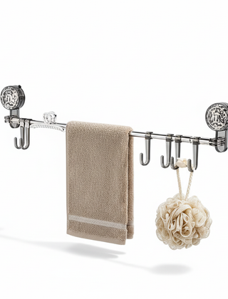 Gray retractable wall hook rack holding a towel and bath sponge