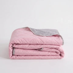 Folded Pink diamond-quilted blanket