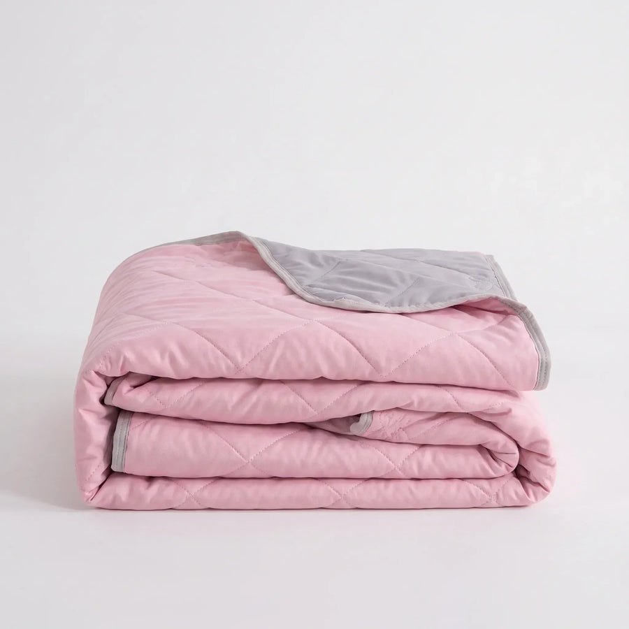 Folded Pink diamond-quilted blanket
