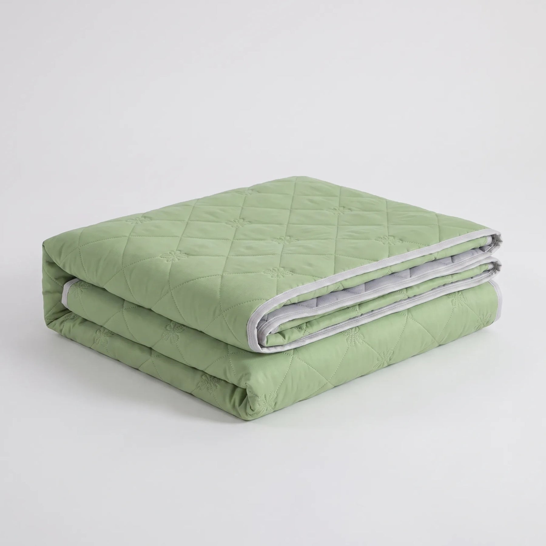 Folded Green diamond-quilted summer blanket