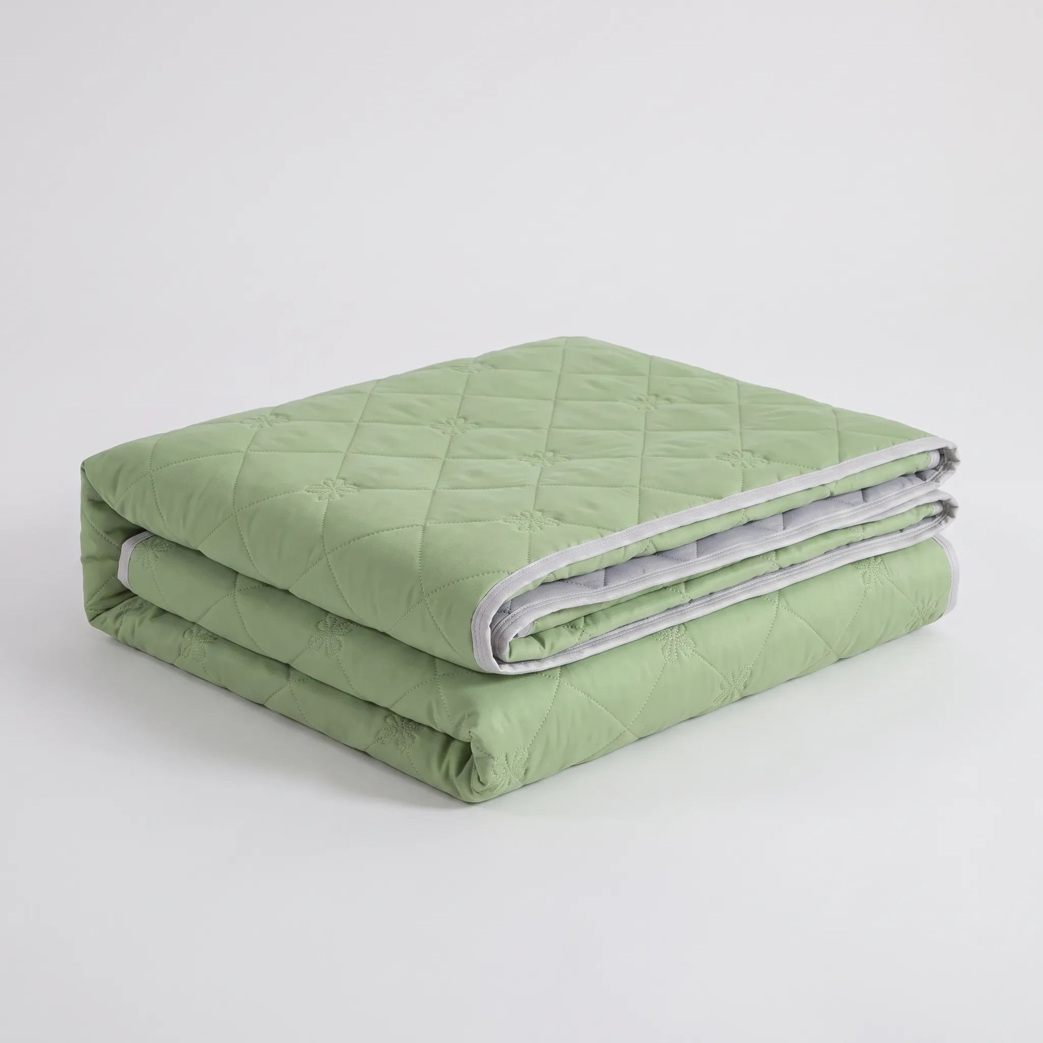 Folded Green diamond-quilted summer blanket