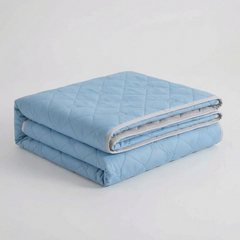 Folded Light Blue diamond-quilted blanket