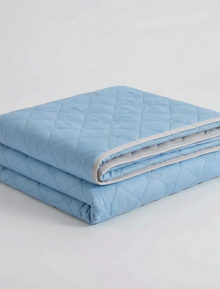 Folded Light Blue diamond-quilted blanket