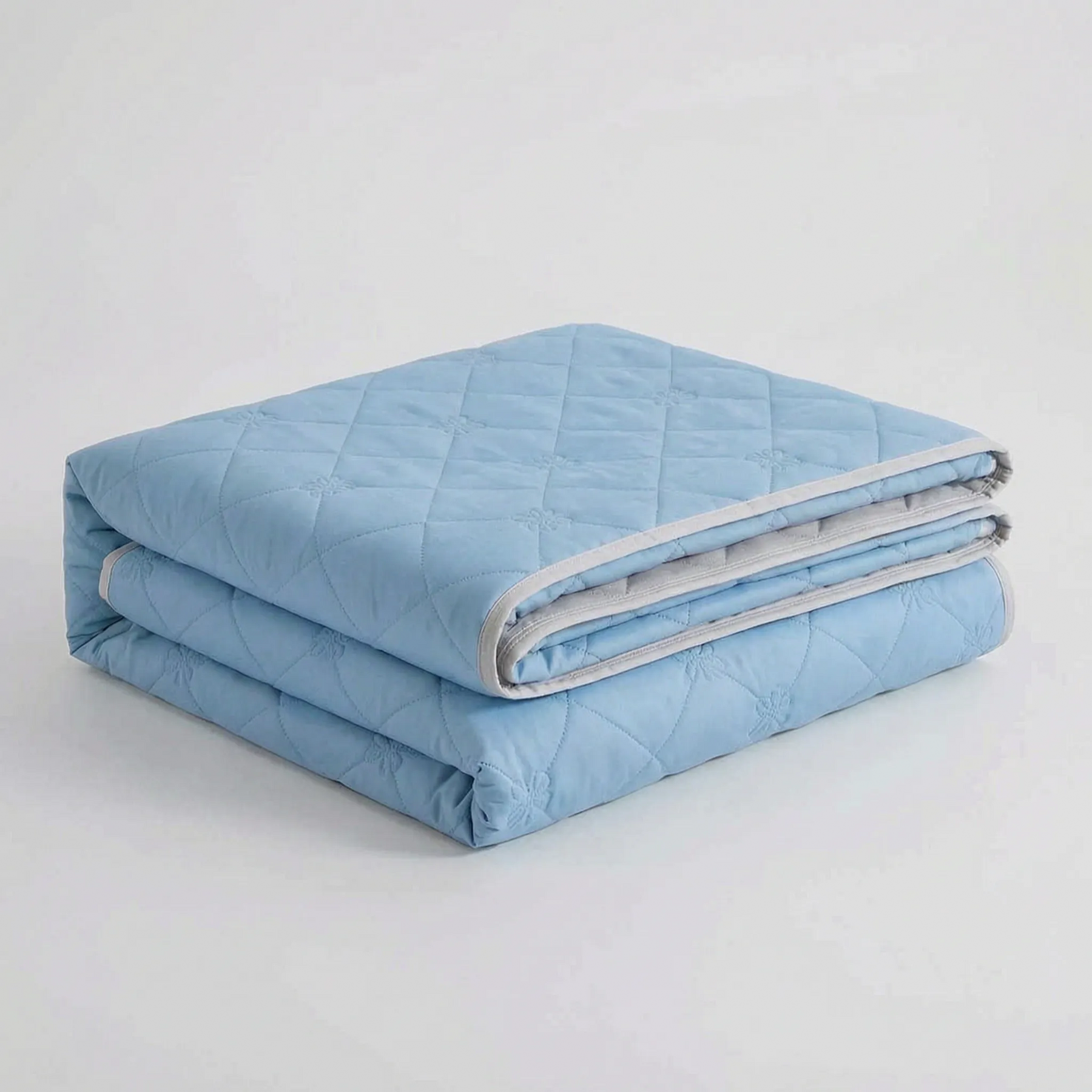 Folded Light Blue diamond-quilted blanket