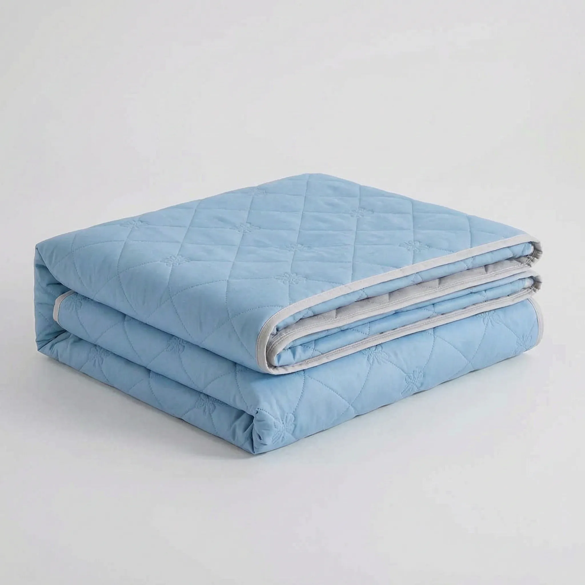 Folded Light Blue diamond-quilted blanket