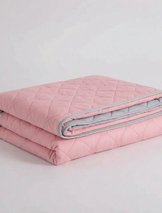 Folded Pink diamond-quilted blanket