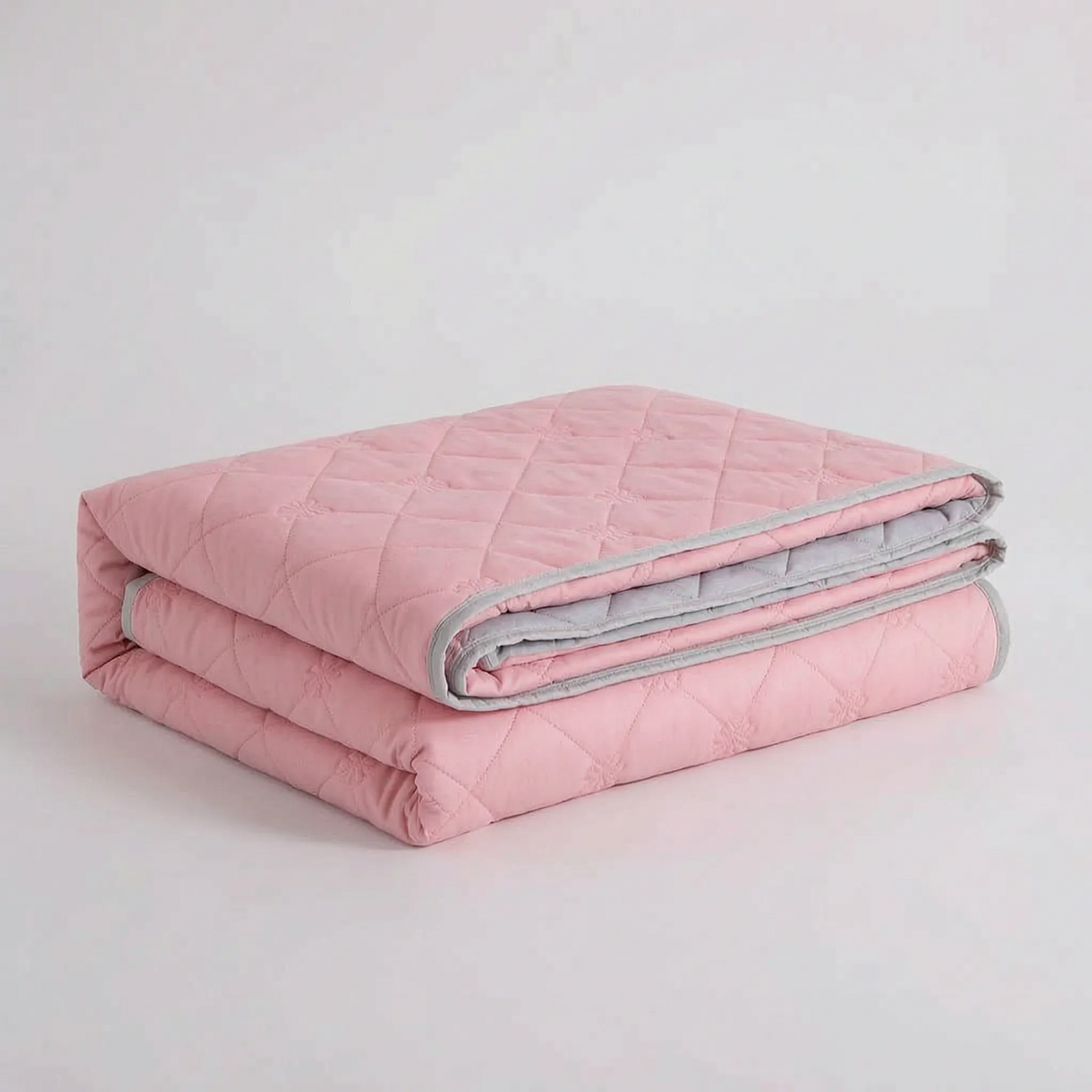 Folded Pink diamond-quilted blanket