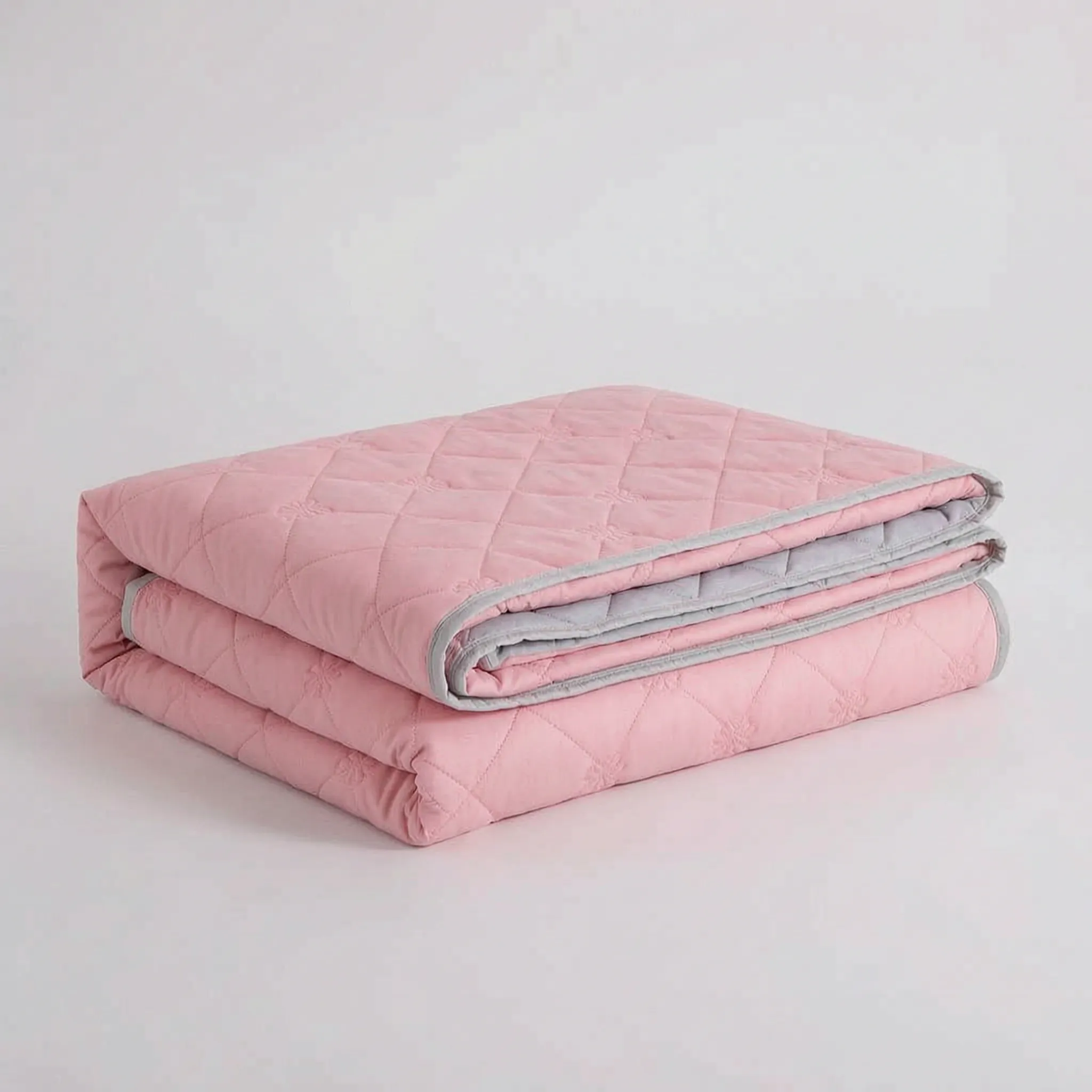 Folded Pink diamond-quilted blanket