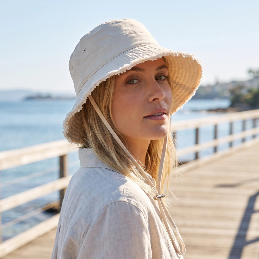 Frayed-edge bucket hat worn beside the water