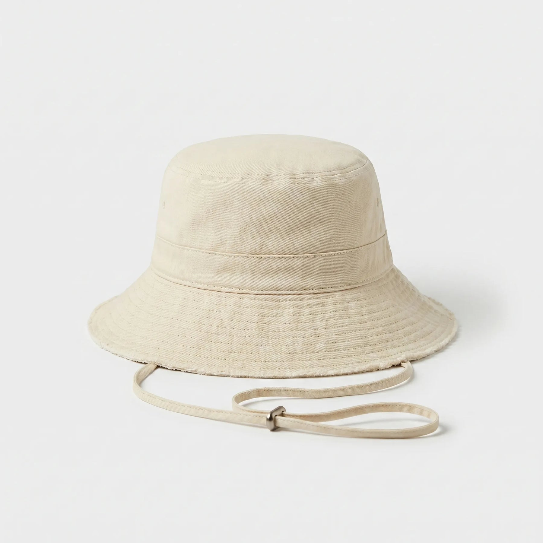 Neutral frayed-edge bucket hat with adjustable chin cord