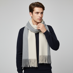 Beige and Gray fringed knit scarf worn over a dark top