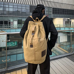 Khaki canvas rucksack worn outdoors