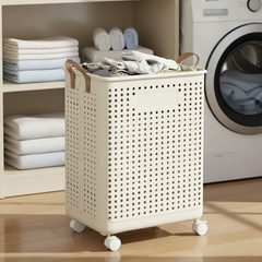 Cream wheeled laundry basket beside a washing machine