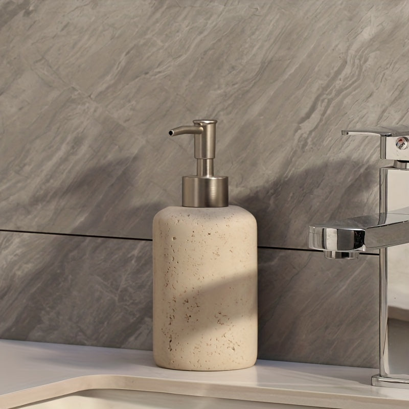 Speckled soap dispenser beside a chrome faucet