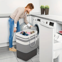 Striped collapsible laundry hamper in a laundry room