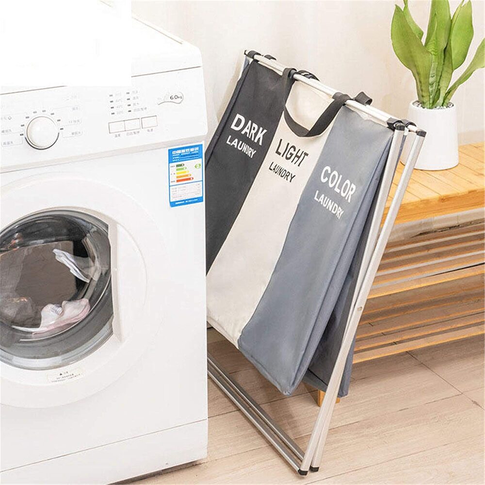 Three-section laundry sorting hamper beside a washing machine