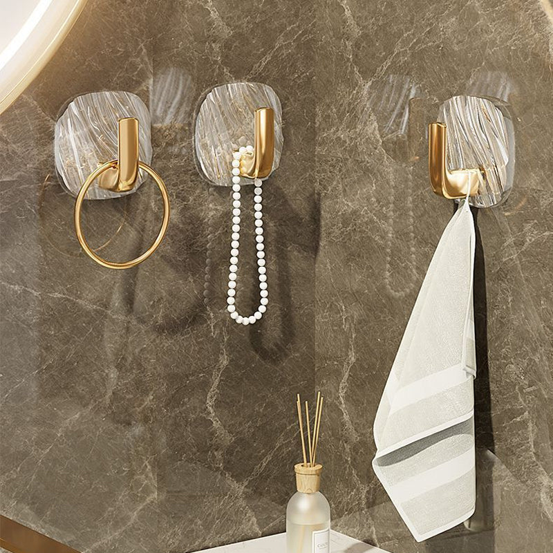 Transparent wall hooks holding bathroom accessories