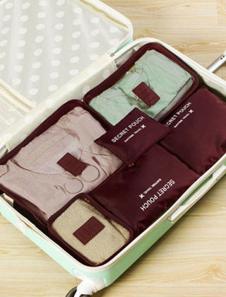 Burgundy packing organizer set inside a suitcase