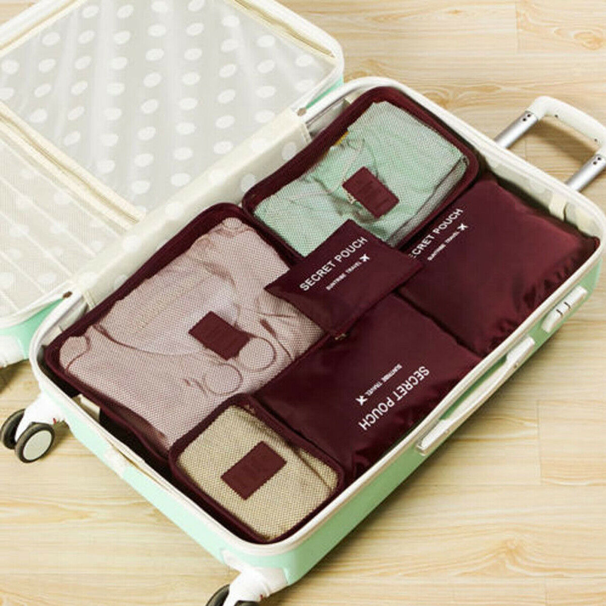 Burgundy packing organizer set inside a suitcase