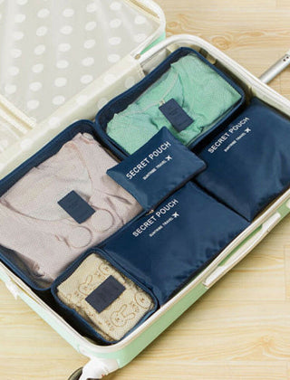 Dark Blue packing organizer set inside a suitcase