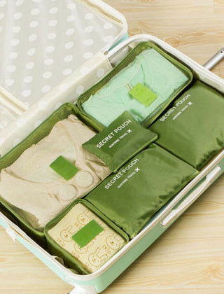 Green packing organizer set inside a suitcase