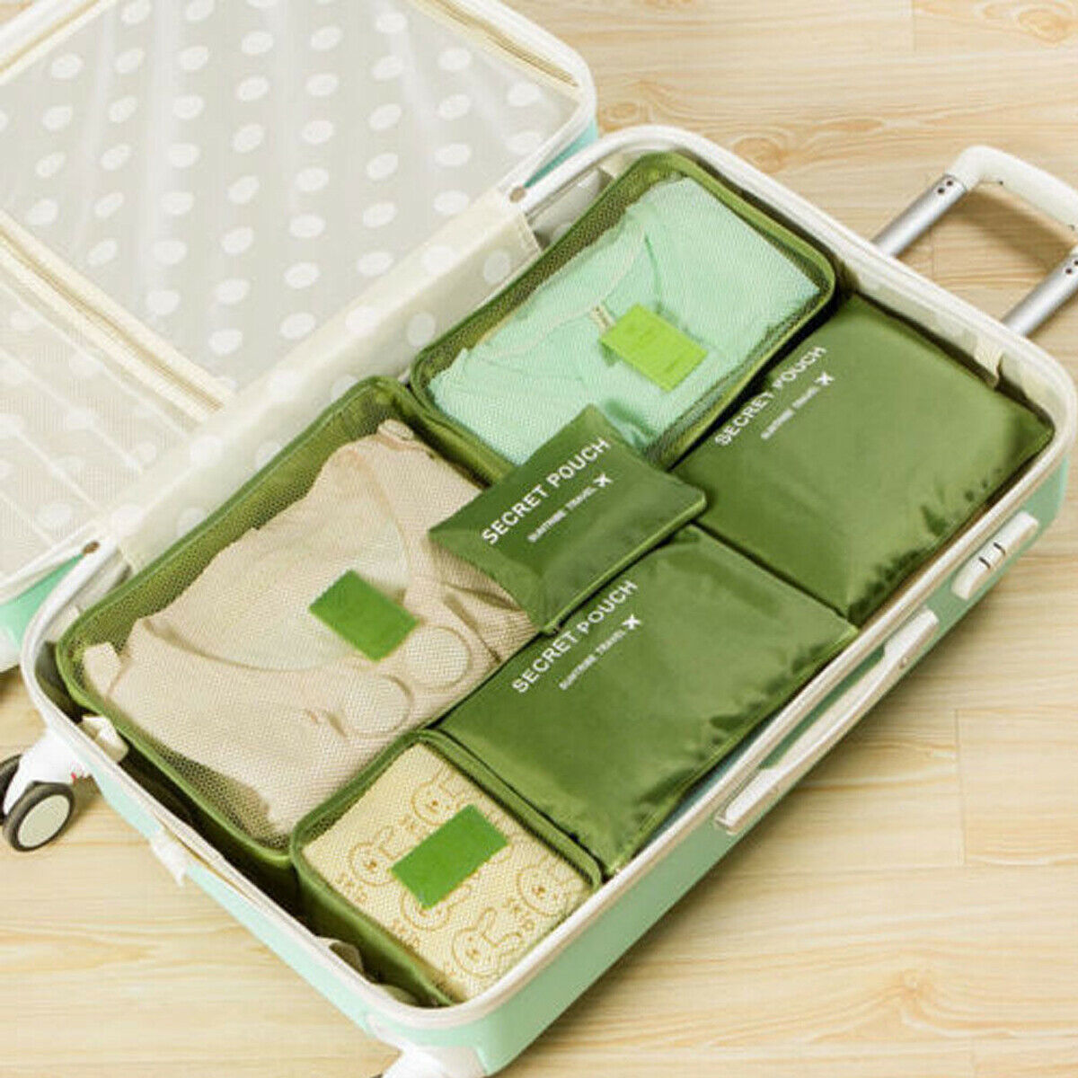 Green packing organizer set inside a suitcase