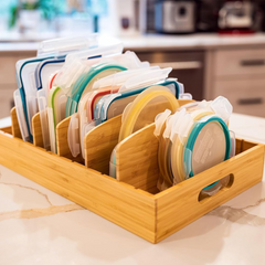 Container lids sorted upright in a bamboo organizer