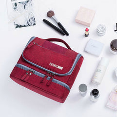 Red toiletry organizer beside travel-size cosmetics
