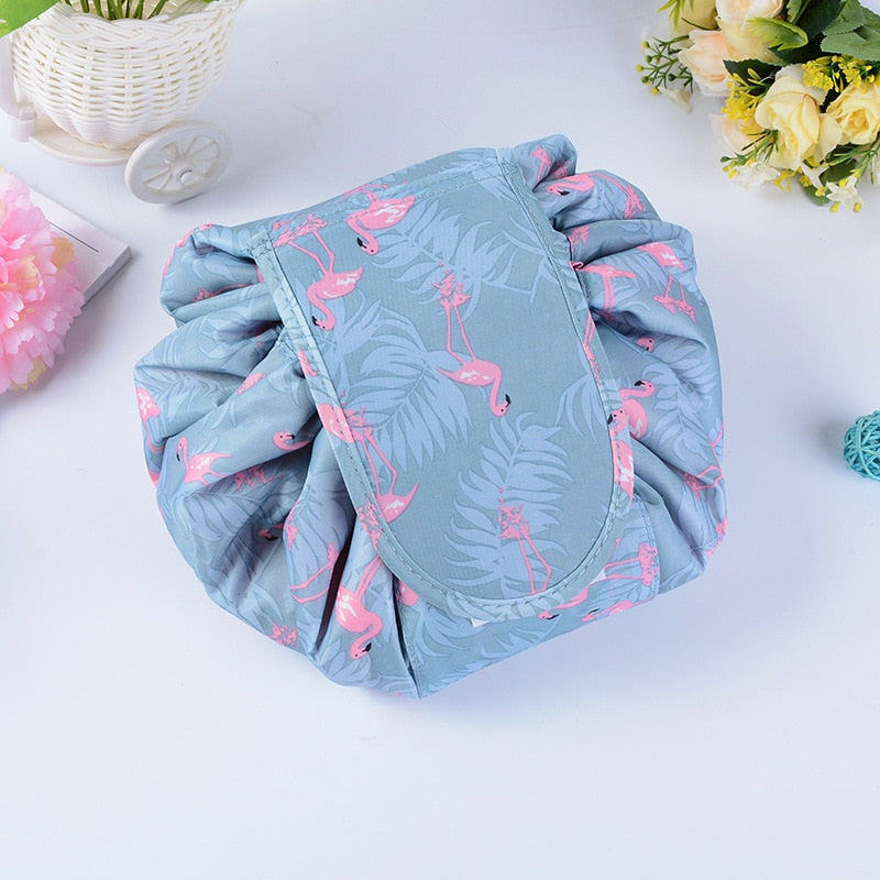 Gray Flamingo cosmetic bag partly opened flat