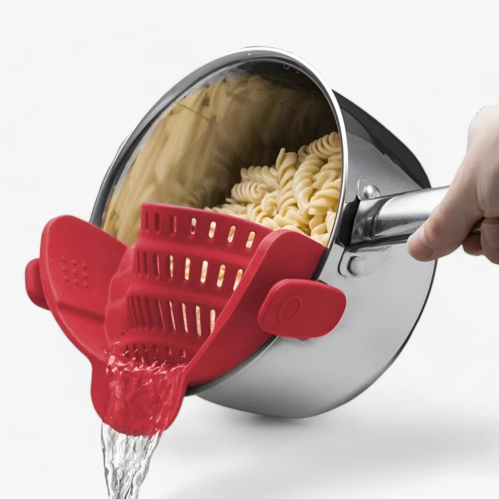 Red clip-on silicone pot strainer draining pasta