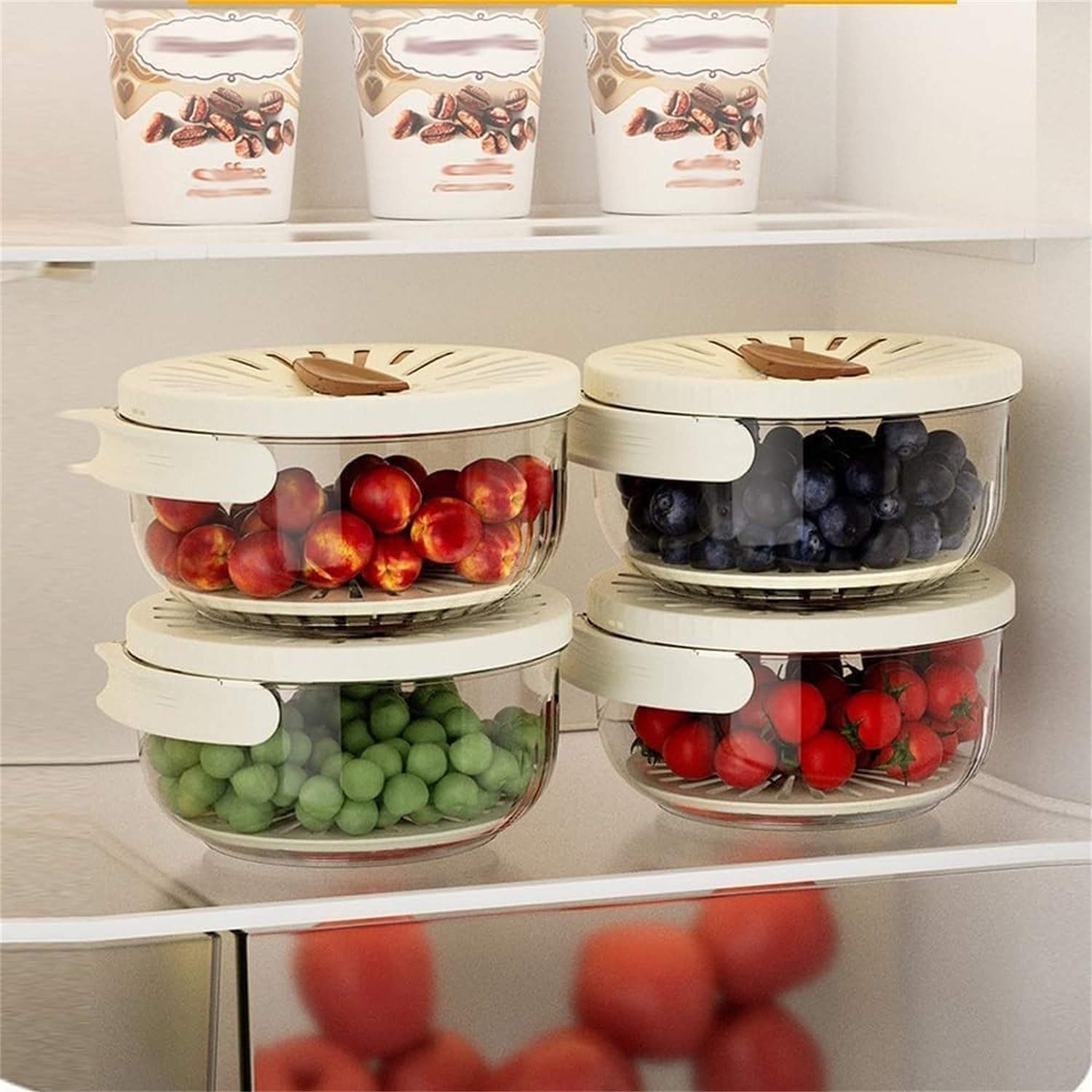 Four round produce containers stacked in a refrigerator
