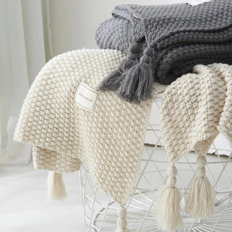 Gray and White knitted tassel throws styled together