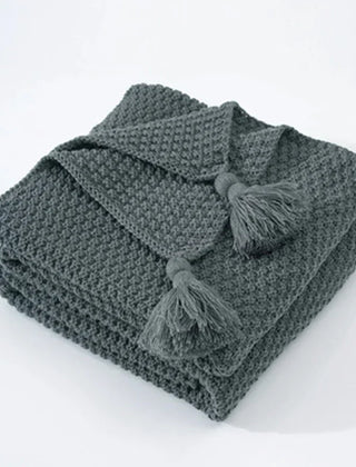 Folded Gray knitted tassel throw