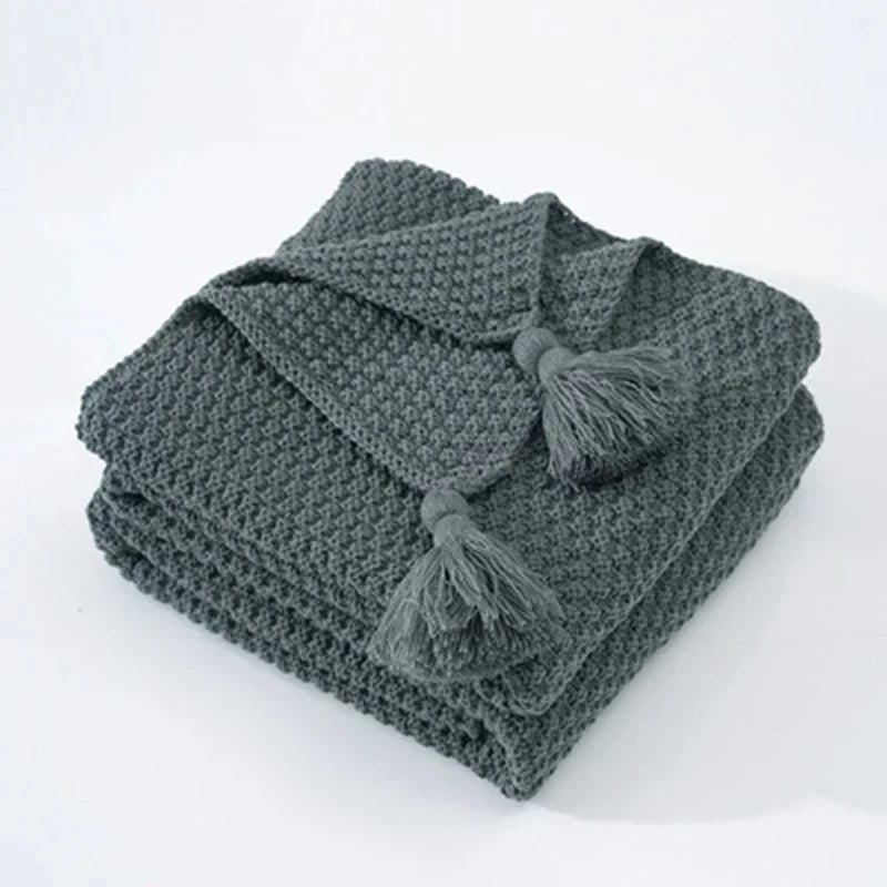 Folded Gray knitted tassel throw