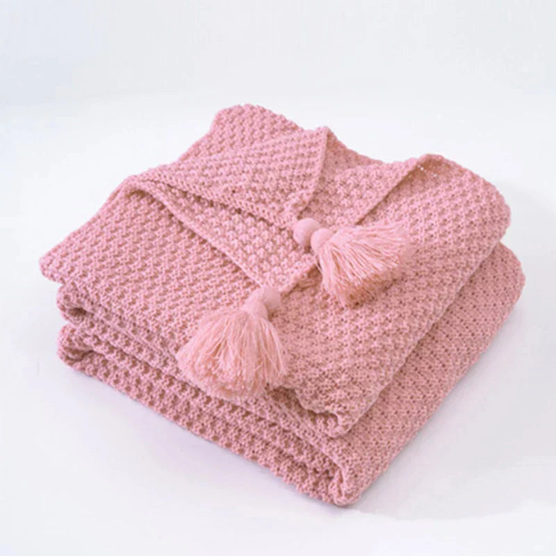 Folded Pink knitted tassel throw