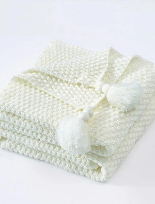 Folded White knitted tassel throw