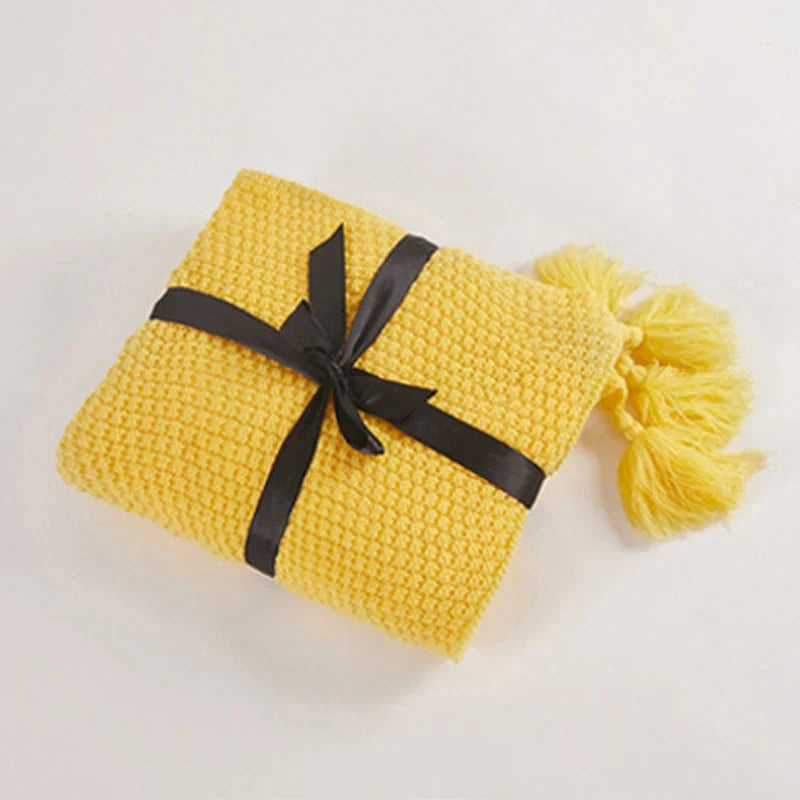 Folded Yellow knitted tassel throw
