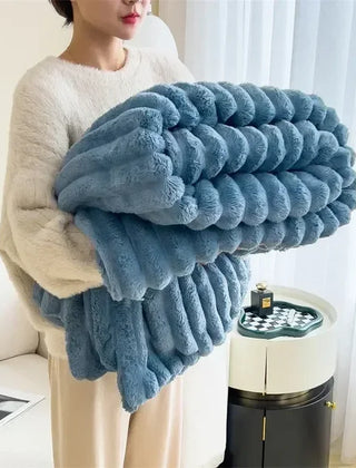 Folded Blue plush ribbed blanket