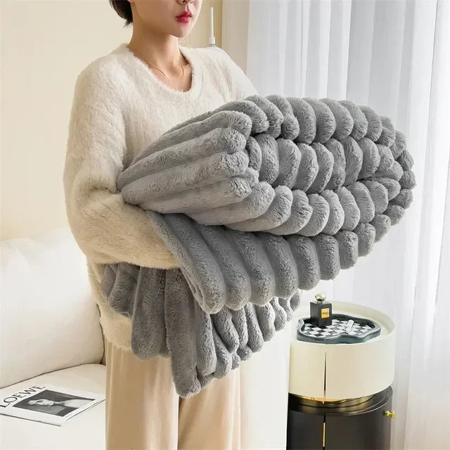 Folded neutral Gray plush ribbed blanket