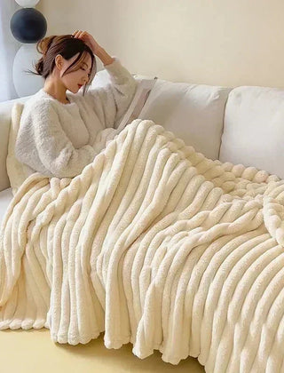 Cream oversized plush ribbed blanket used on a sofa
