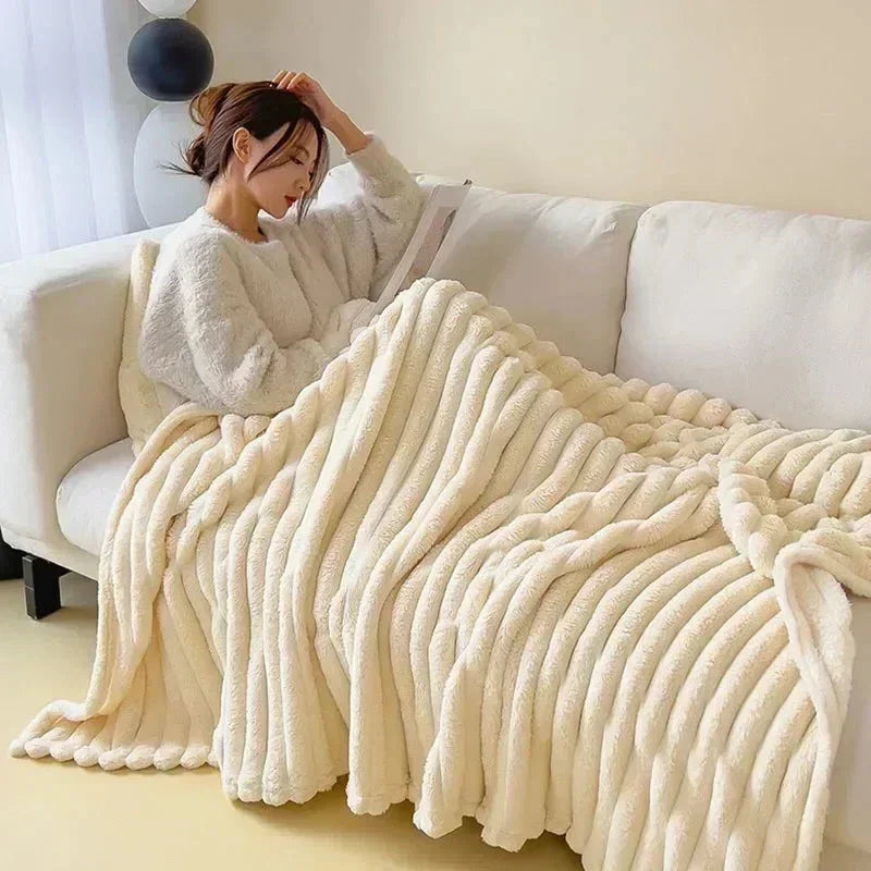 Cream oversized plush ribbed blanket used on a sofa