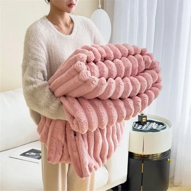 Folded Pink plush ribbed comfort blanket