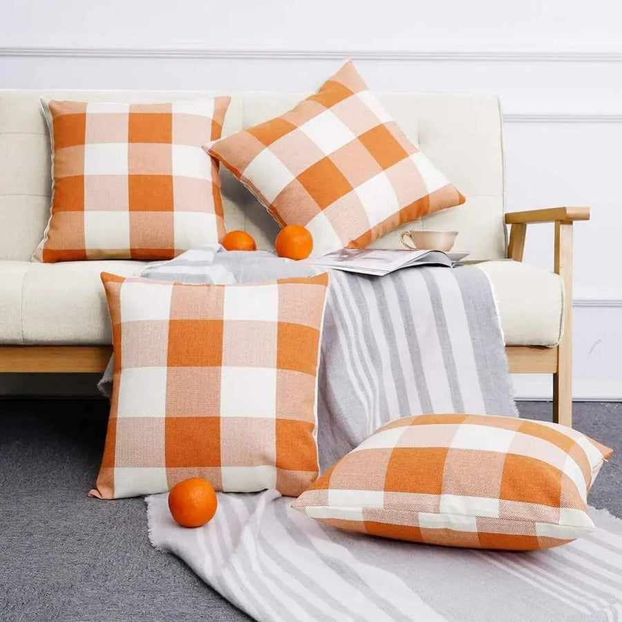 Orange plaid cushion covers styled on a sofa